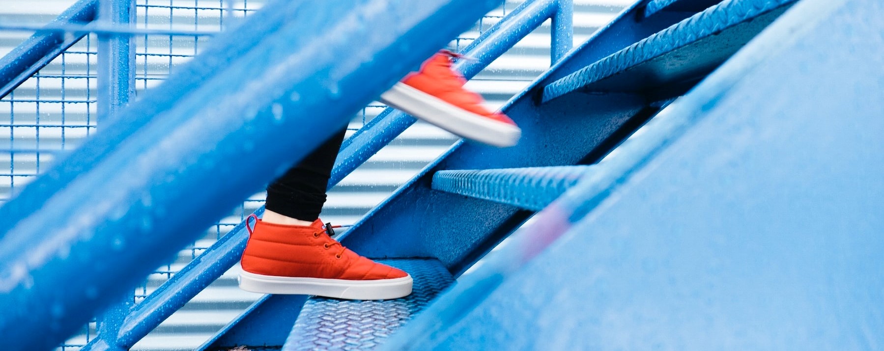 Person stepping on blue stairs by Lindsay Henwood, CC0